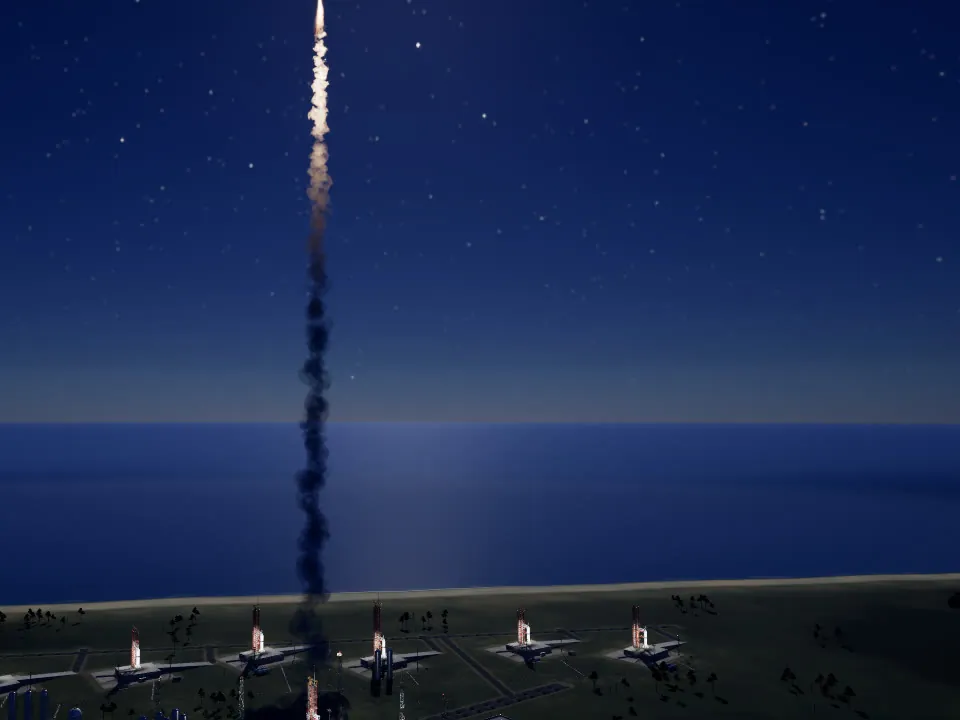 A rocket's exhaust trail rising into the night sky over a row of lit launch pads by the sea.